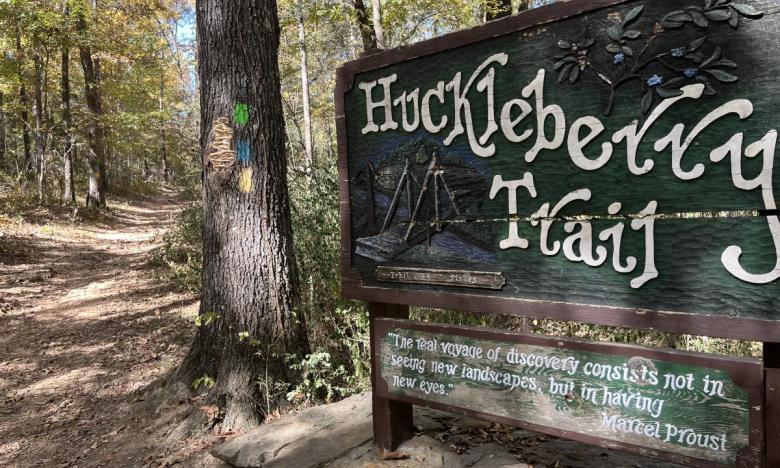 Sign for Huckleberry Trail at Woolly Hollow State Park. 